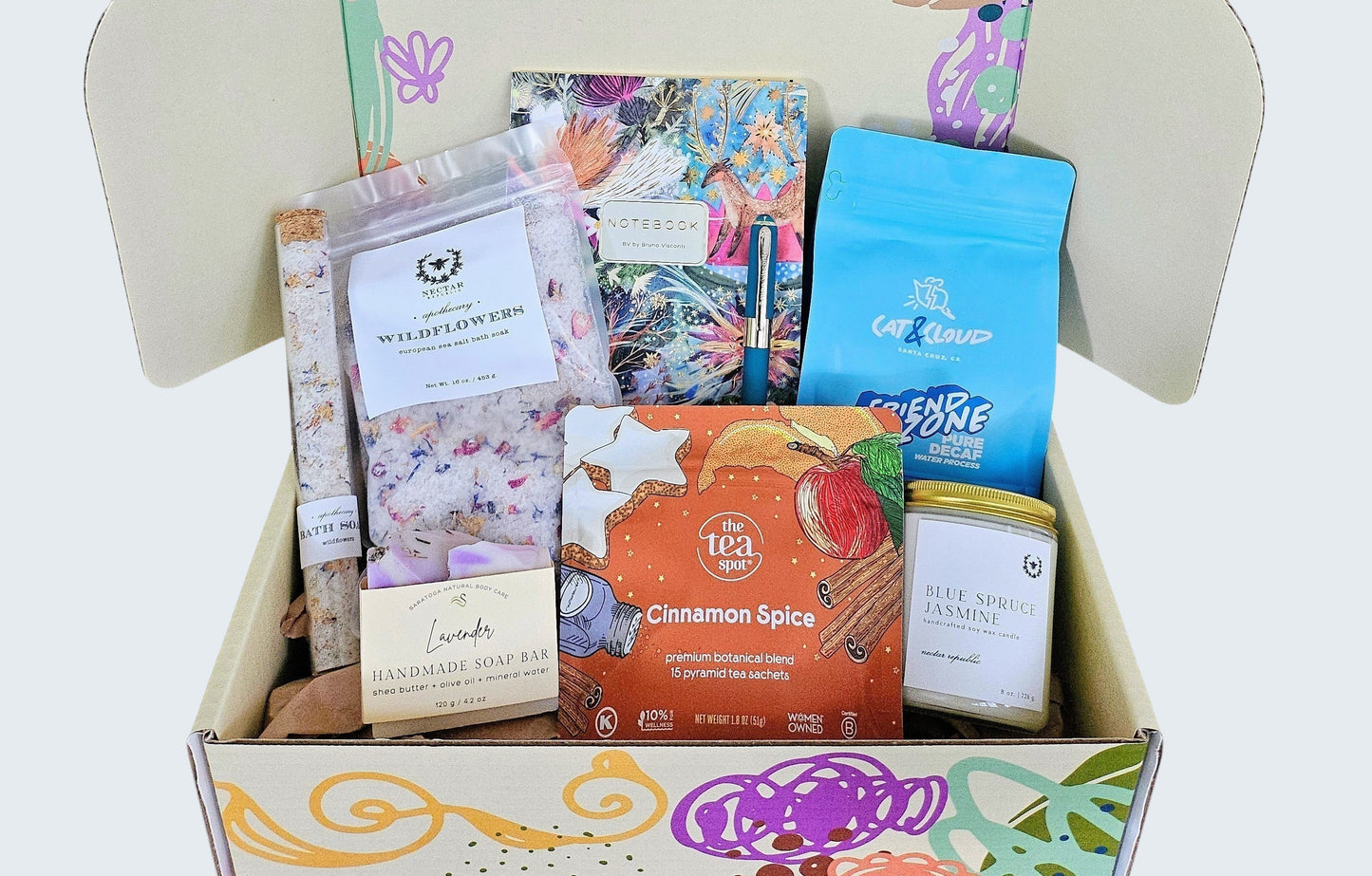 Spa gift box including candles, bath soak, luxurious handmade soap, cinnamon spice tea, small batch decaf coffee beans for post dinner treat, and a beautiful notebook and pen to journal and reflect on the day; slow living at it's finest with Grounded Living.